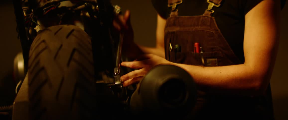 A person working on a motorcycle with a socket