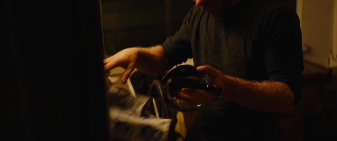 A man wiping off goggles in a room