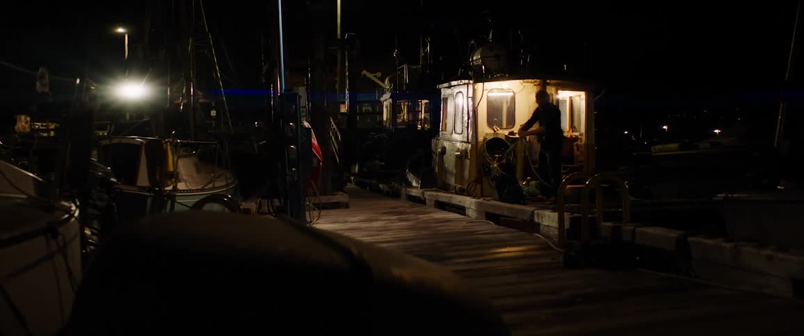 A person is gathering rope on the boat