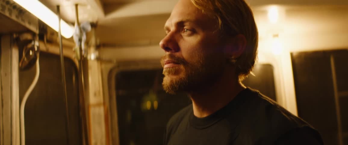 A man standing on a boat cabin with lights