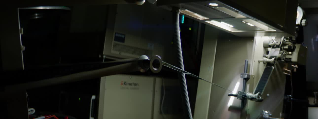 A film projector projecting film in the dark