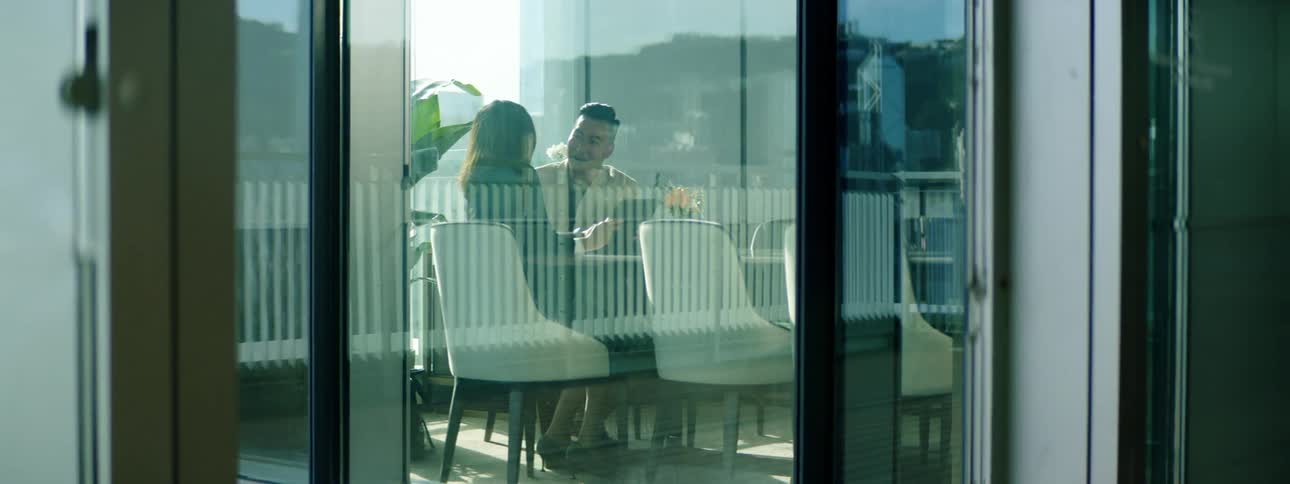 A man and woman sitting in an office talking