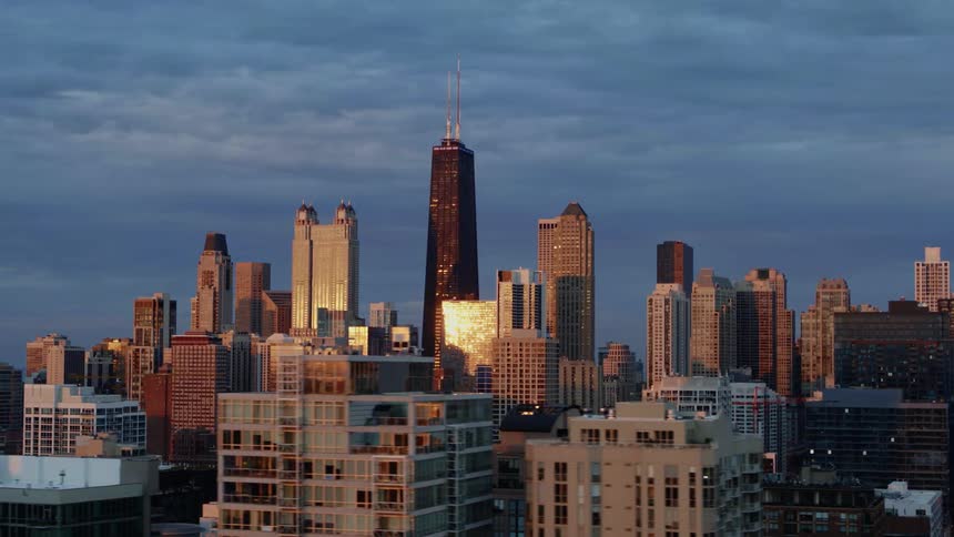 Sunlight reflects off the center of Chicago skyscrapers at dusk