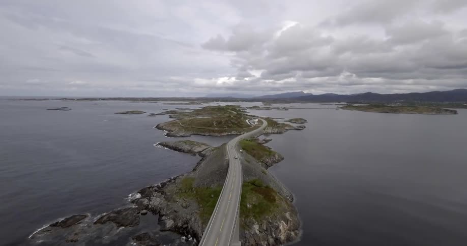 Cars driving over a tall bridge over a body of water
