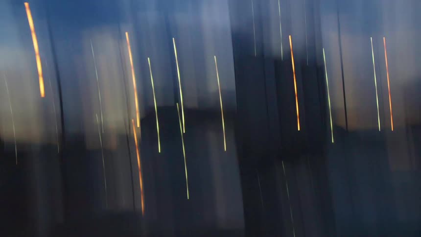Lights come on in high rise buildings as day turns to night