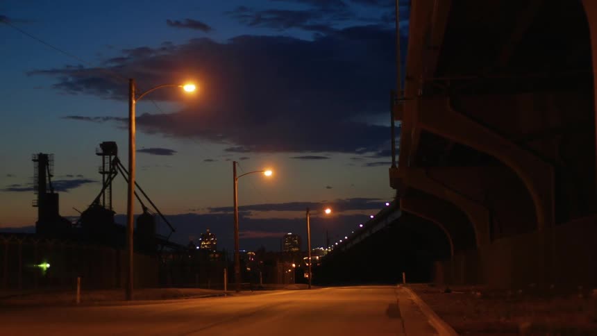 A bridge runs alongside a road that leads to downtown