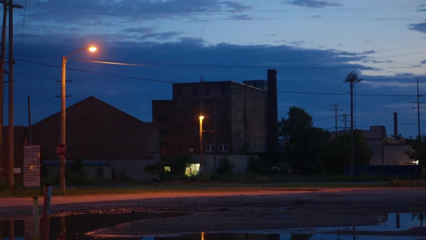 The area surrounding a factory in a city is empty at night