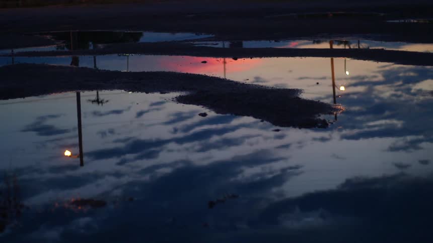 The reflection of clouds in a pool of water
