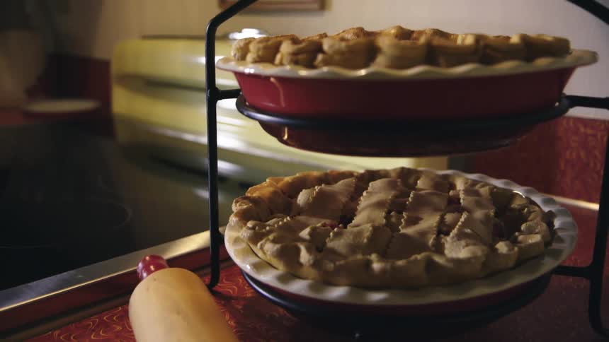 Homemade apple pies cooling on a rack on a countertop