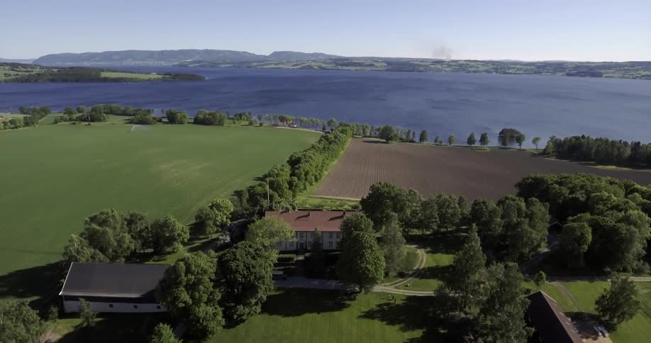 Large house and farm near a body of water