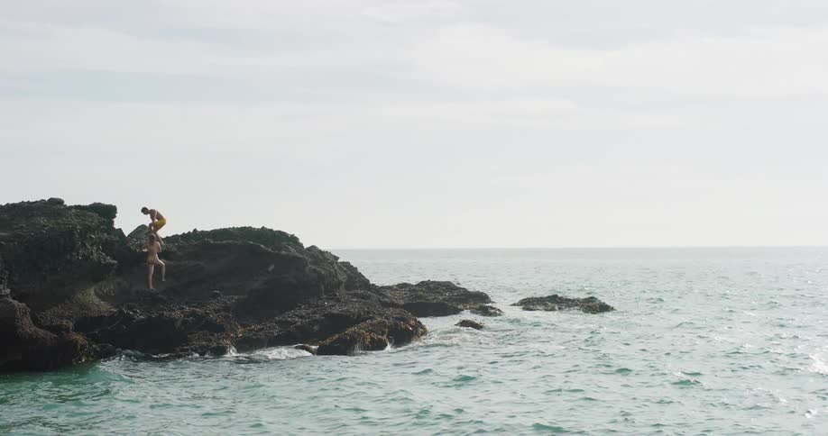 Two people are by the beach during the day