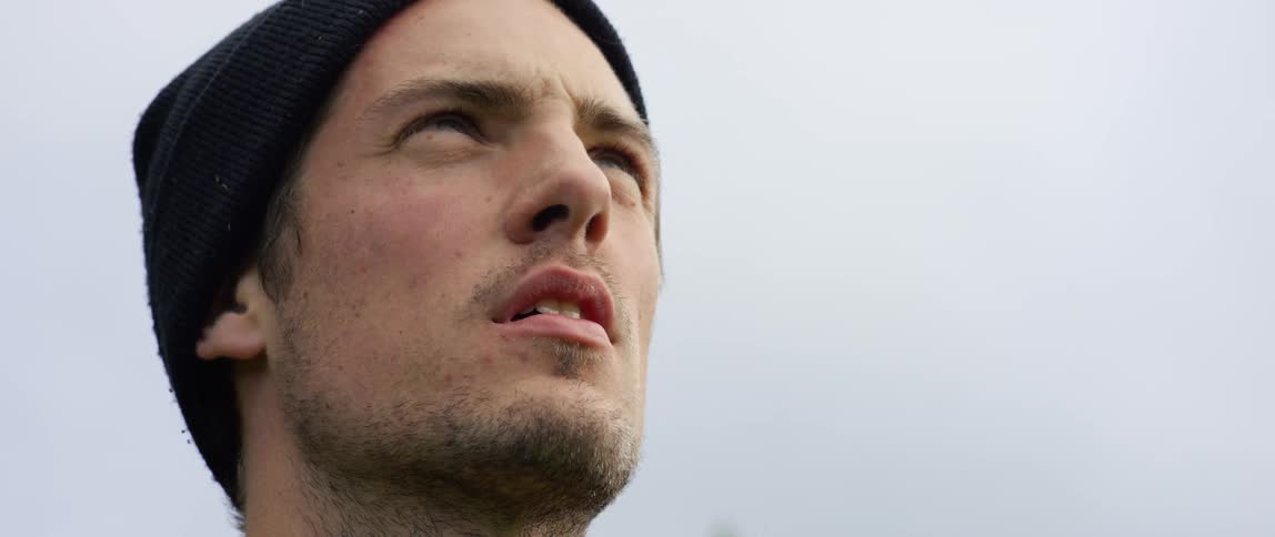 A man is wearing a beanie outdoors