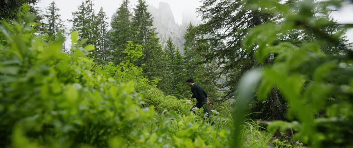 A man is hiking through the wilderness