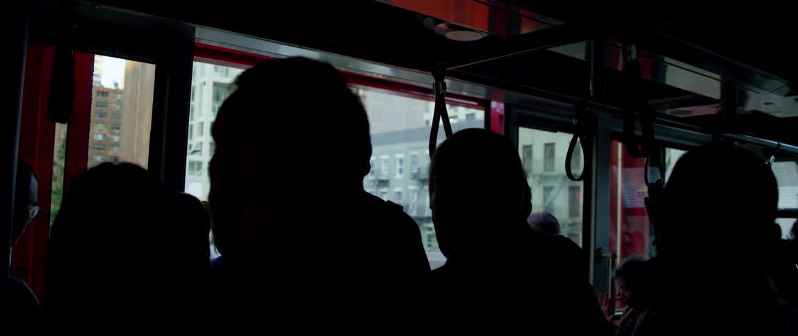 A group of people standing on a subway and then the doors open and they exit