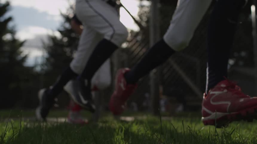 Baseball players running onto the field