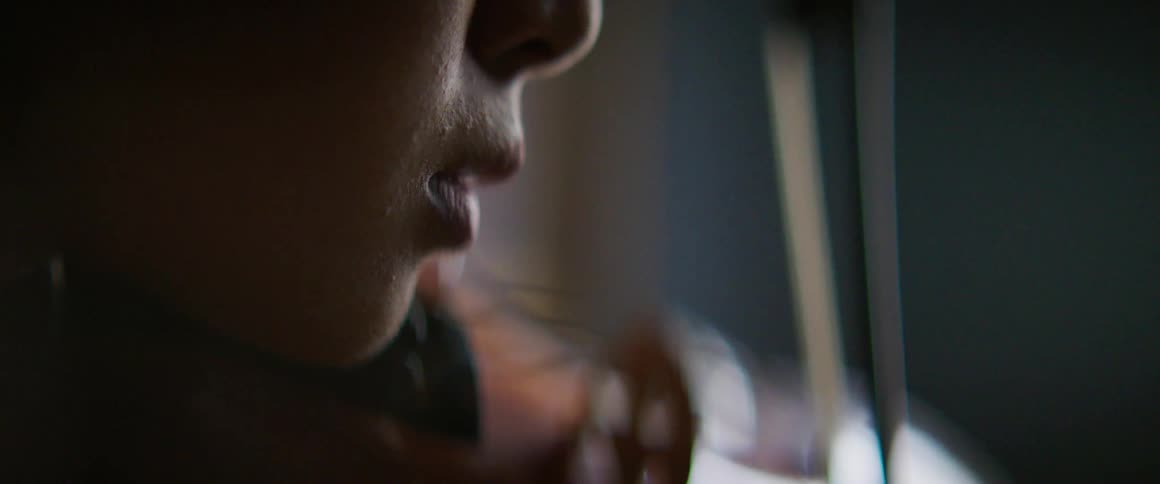 Woman plays string instrument reflecting light