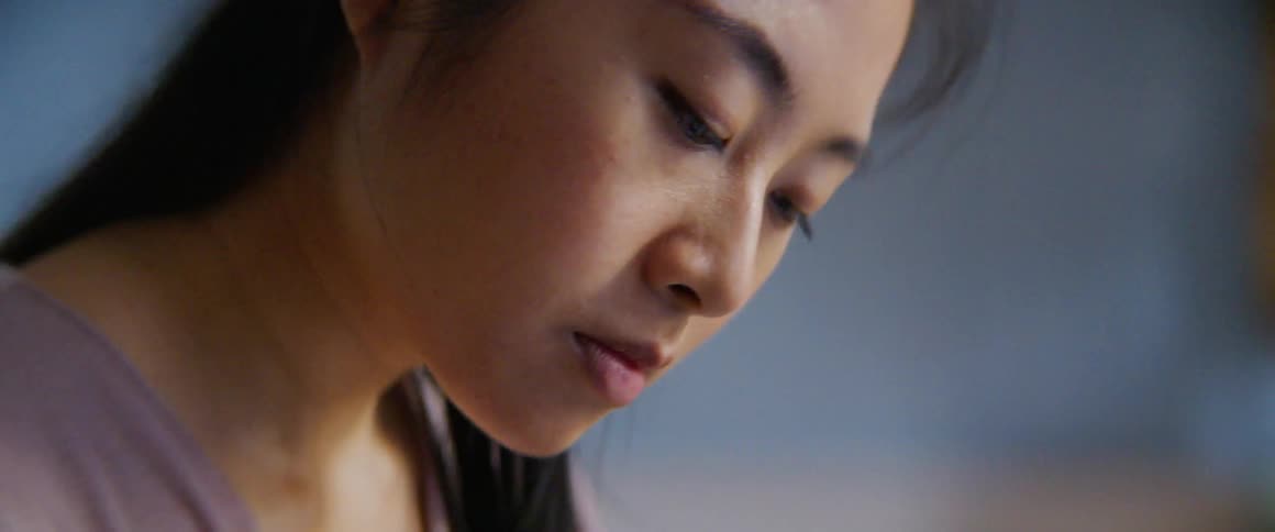 A woman is looking down in the room