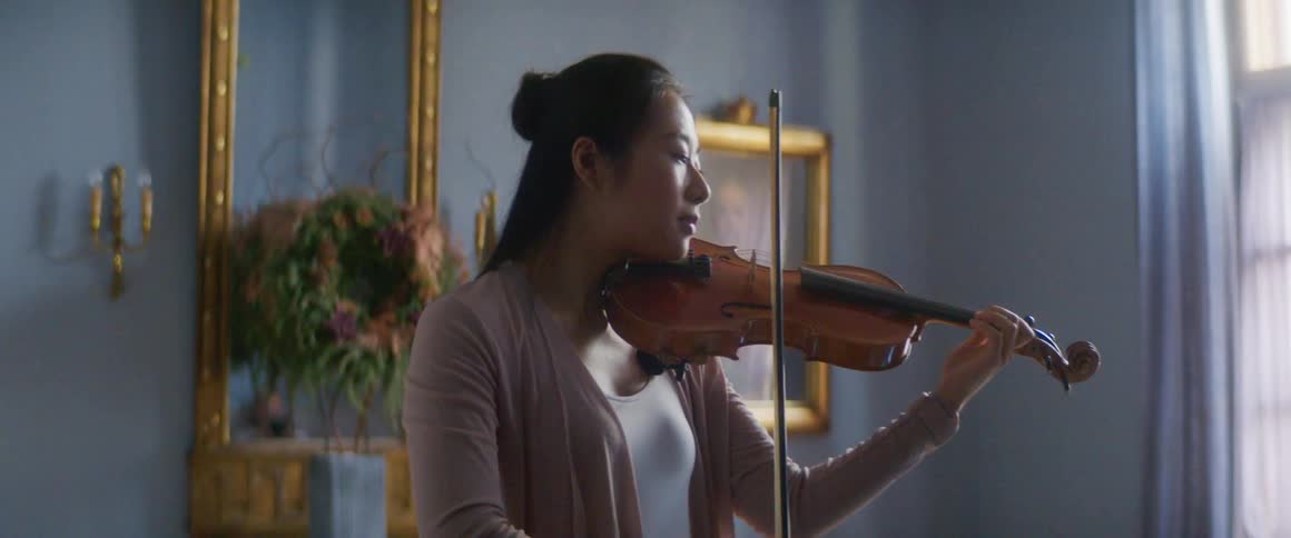 A woman is playing an instrument indoors