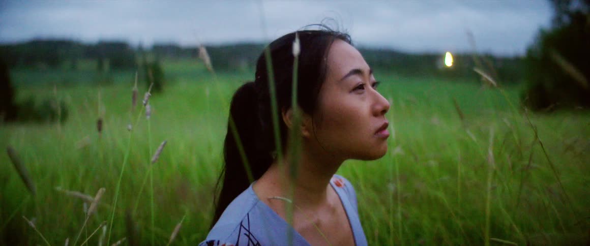 A woman is standing outdoors in spring