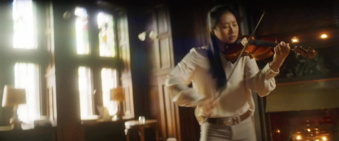 A woman is playing a violin instrument