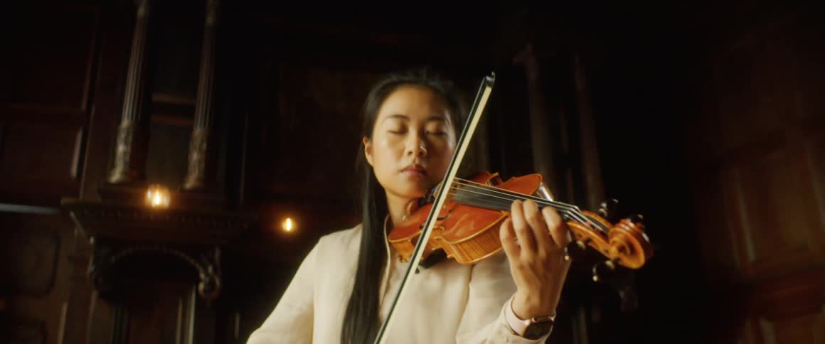 A young woman playing a violin
