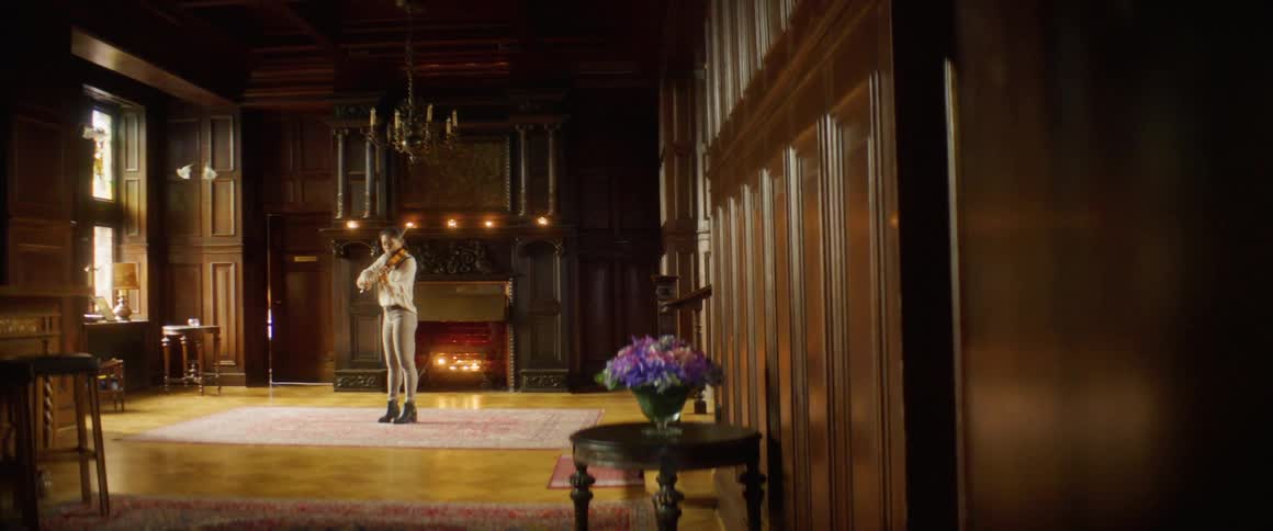 A woman is playing an instrument indoors