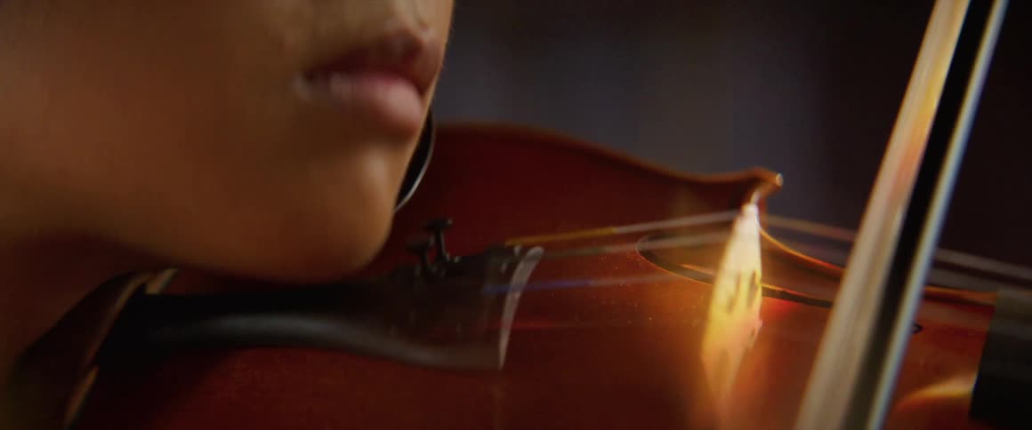 A woman is playing an instrument indoors