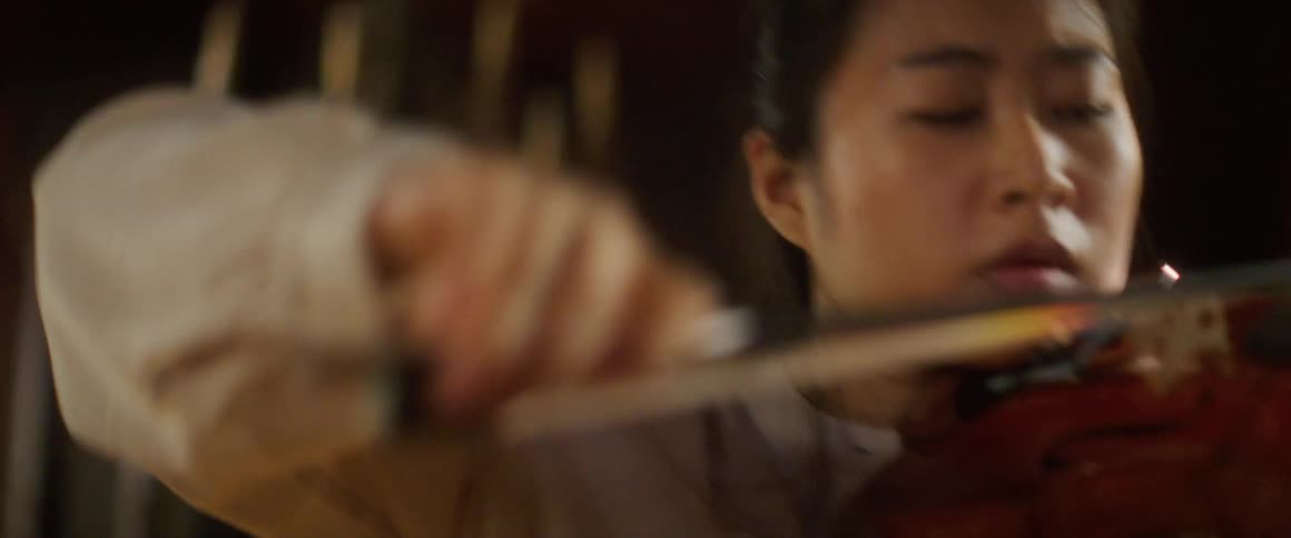A woman is playing the violin