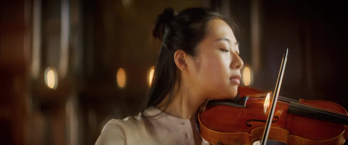 A woman is playing an instrument indoors