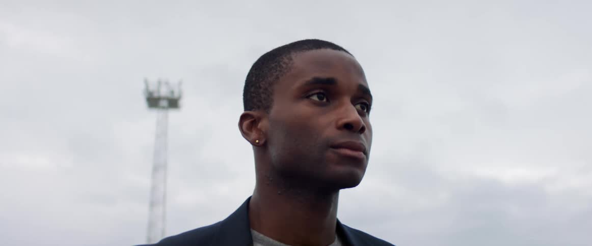 A man is standing outdoors in the daytime