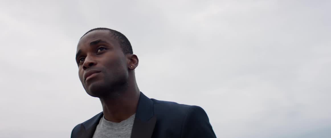 A man is standing outdoors during the day