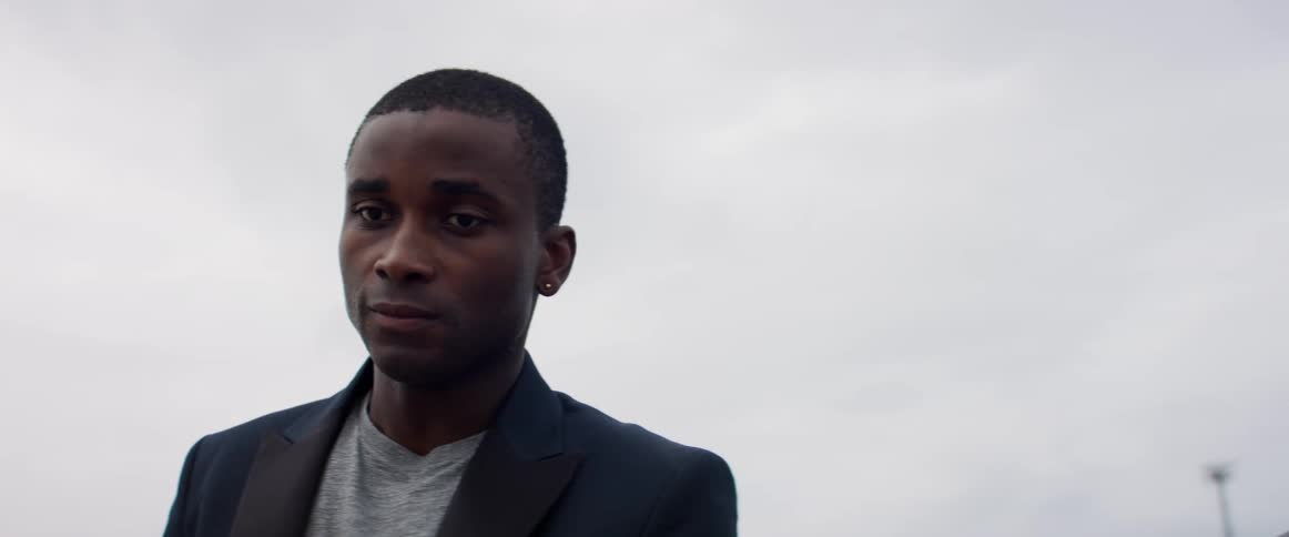 A man is standing outdoors during the day