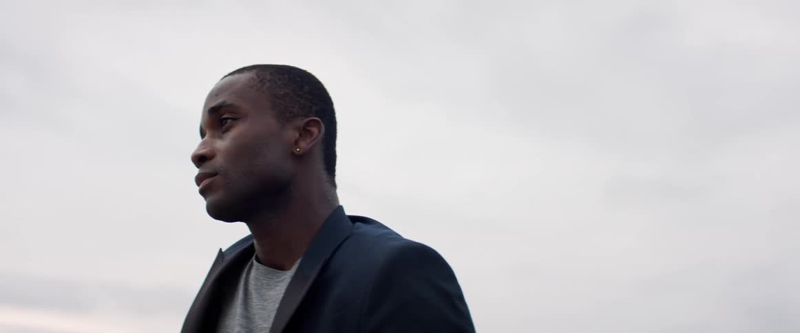 A man is standing outdoors in the daytime