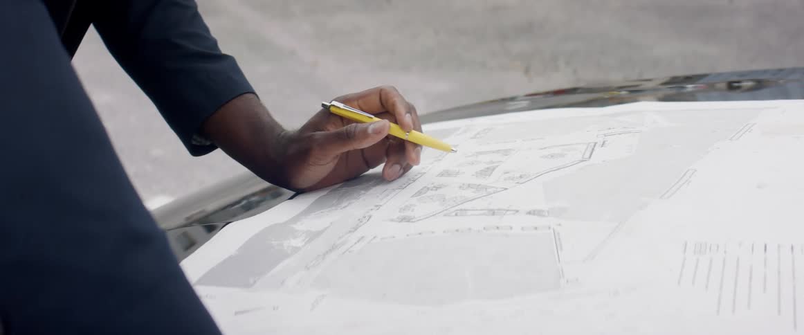 A person is looking over blueprints
