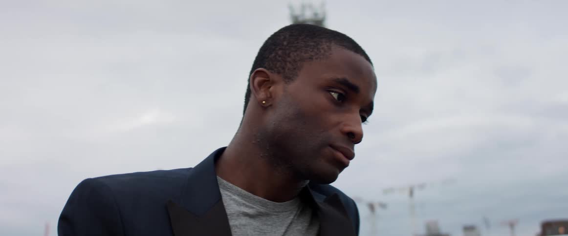 A man is standing outdoors in a city