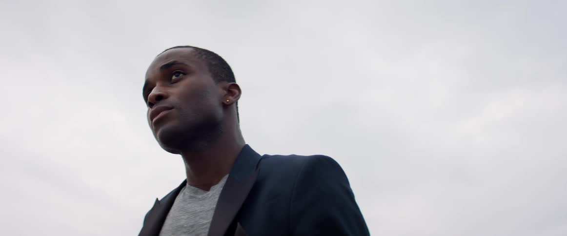 A man is standing outdoors during the day
