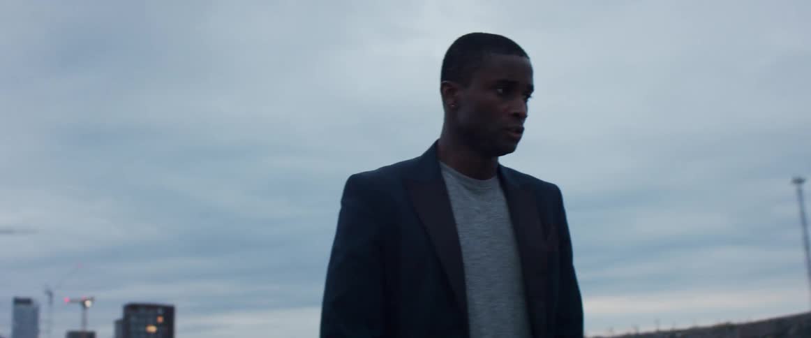 A man is standing outdoors in a city
