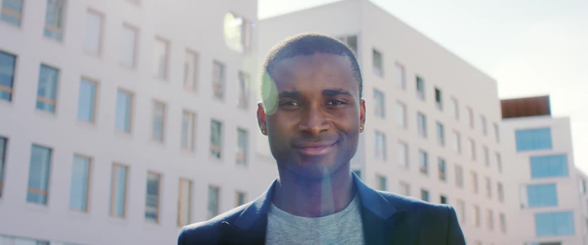 A man is standing outdoors during the day