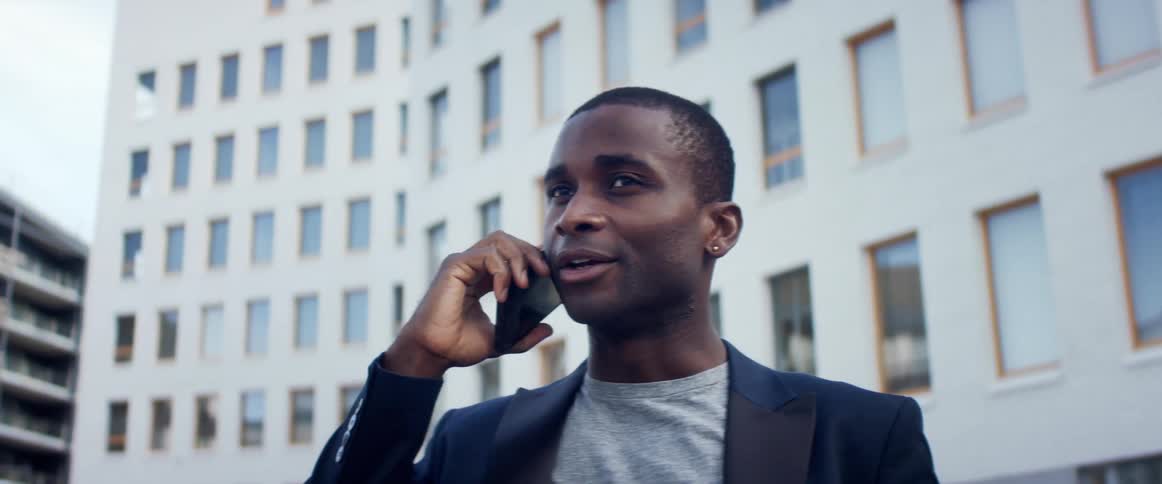 A man is talking on his cellphone outdoors