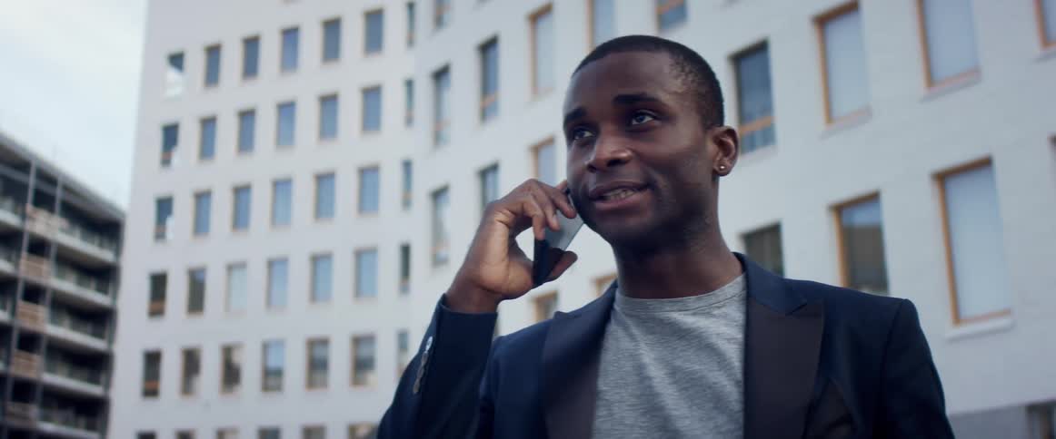 A man is talking on his cell phone in a downtown
