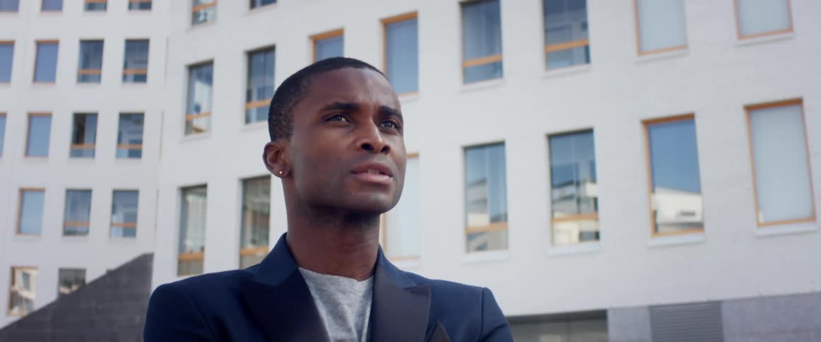 A man is wearing a suit in a city