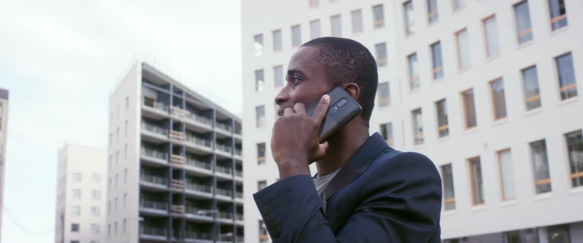 A man is talking on his cell phone in a city