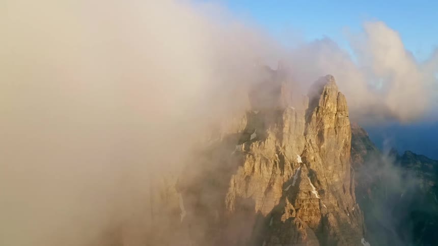 Clouds are covering the mountains at dusk