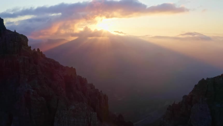 An aerial view of the sun over a mountain range