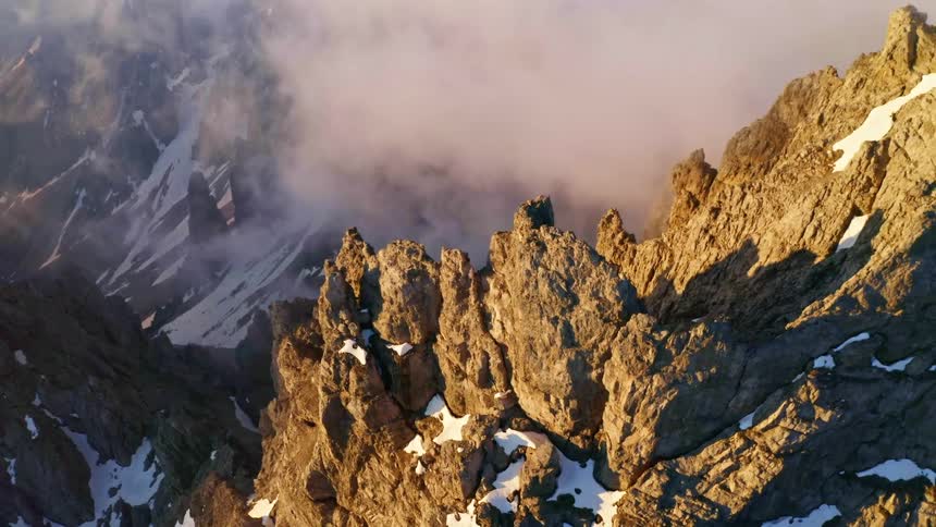 A mountain range with sunlight shadow snow and ice