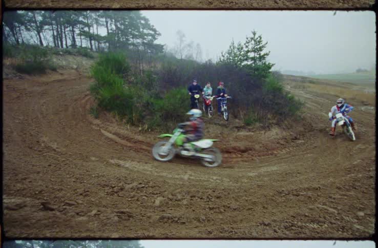 People are racing on on dirt bikes