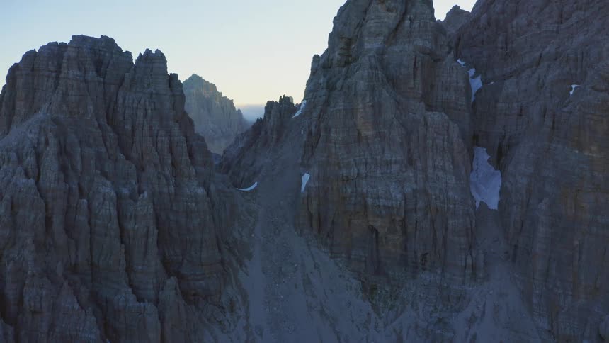 Steep rocky mountains with snow in the wilderness