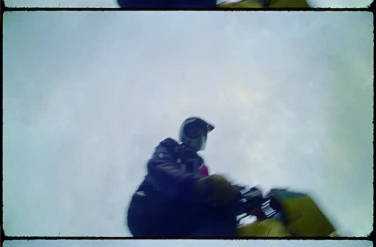 A film strip with a close up of a person riding a motorbike