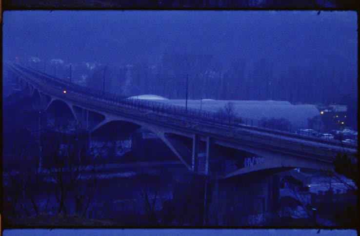 Film footage of cars driving on streets in the winter