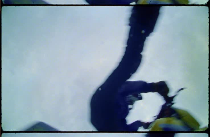 Person riding dirt bike over a jump and swinging out legs
